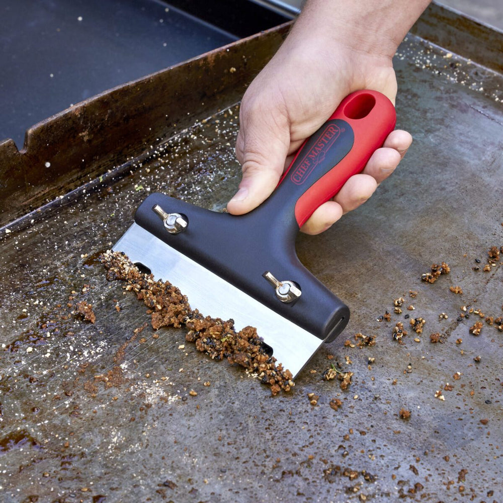 Chef Master 90276 Grill Scraper shown cleaning flattop grill