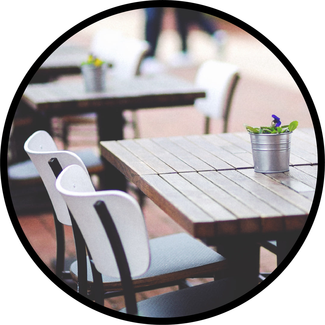 Commercial Outdoor Restaurant Furniture setup on a brick patio seating area for a bistro
